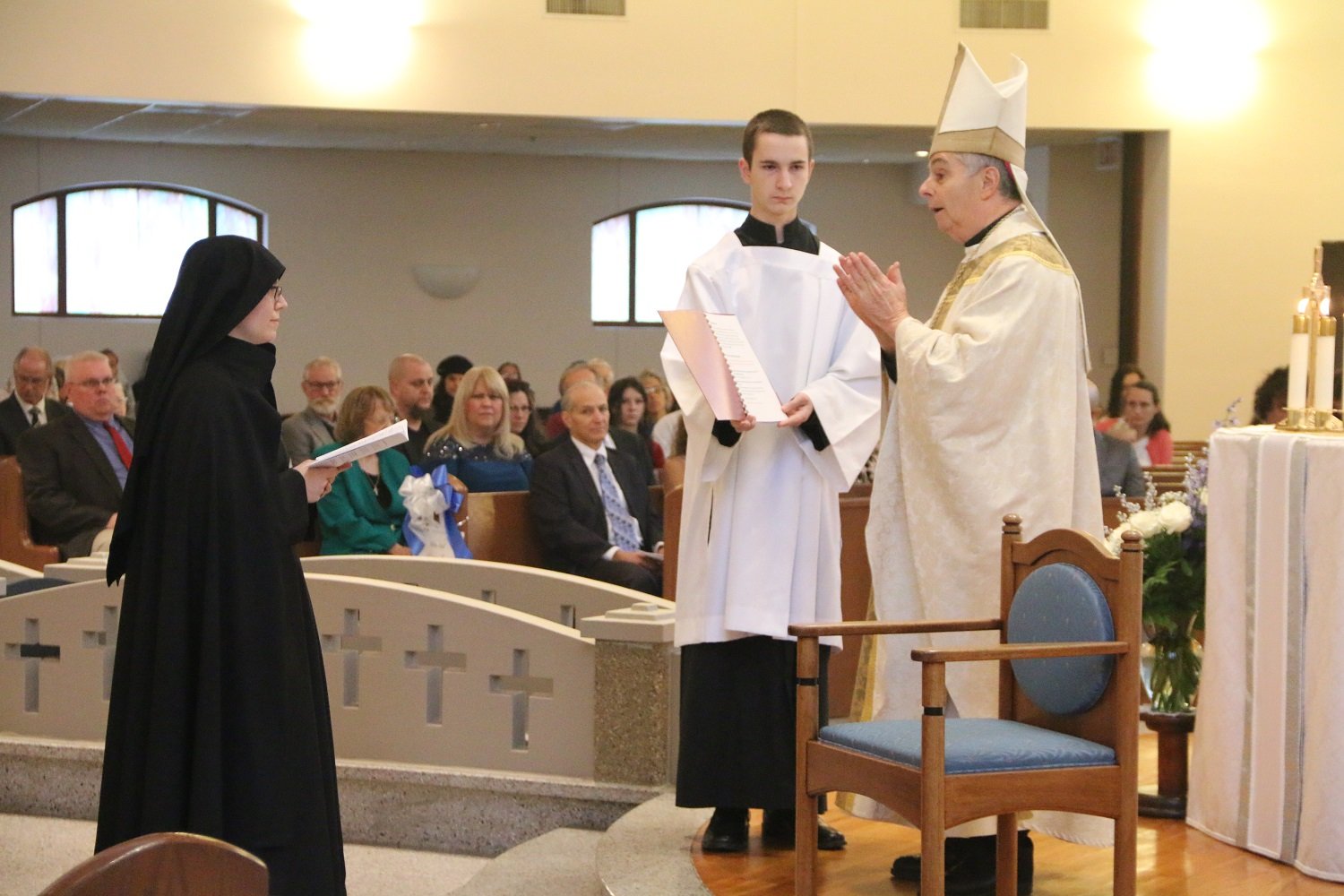  The rite of calling - after the Gospel, Bishop Medley speaks in the name of God and of the Church, formally calling Sr. Maria Faustina to perpetual profession. Sister accepts, and all reply, “THANKS BE TO GOD!”   (Photo: Elizabeth Wong Barnstead, We