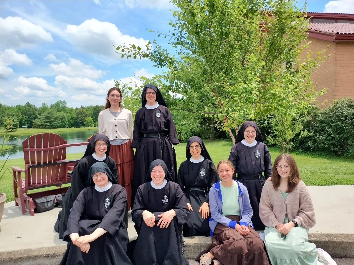 Back row (standing): Madeline and Sr. Bethany Marie  Middle row (kneeling): Sisters Cecilia Maria, Mary Andrea, and Frances Marie  Front row (sitting): Sisters Miriam Esther and Isabel Maria, Angela, Olivia 