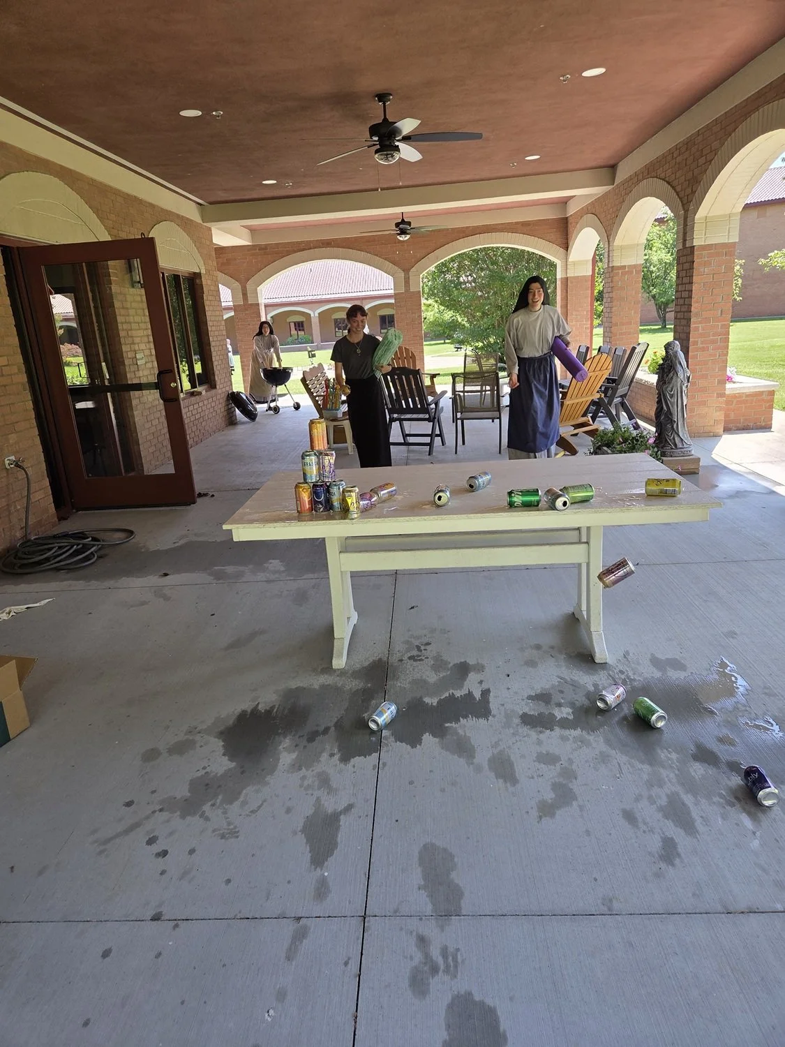  …and then, properly dizzy, attempting to use a ball to knock down water-filled cans. 