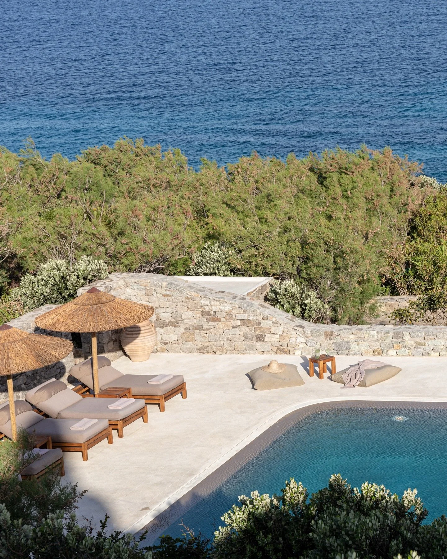 Set above a semi-private sandy beach, this 7 bedroom villa, available for private rental, has been thoughtfully redesigned to blend&nbsp;Cycladic charm with contemporary elegance. Surrounded by gardens leading directly to the beach, the villa offers&