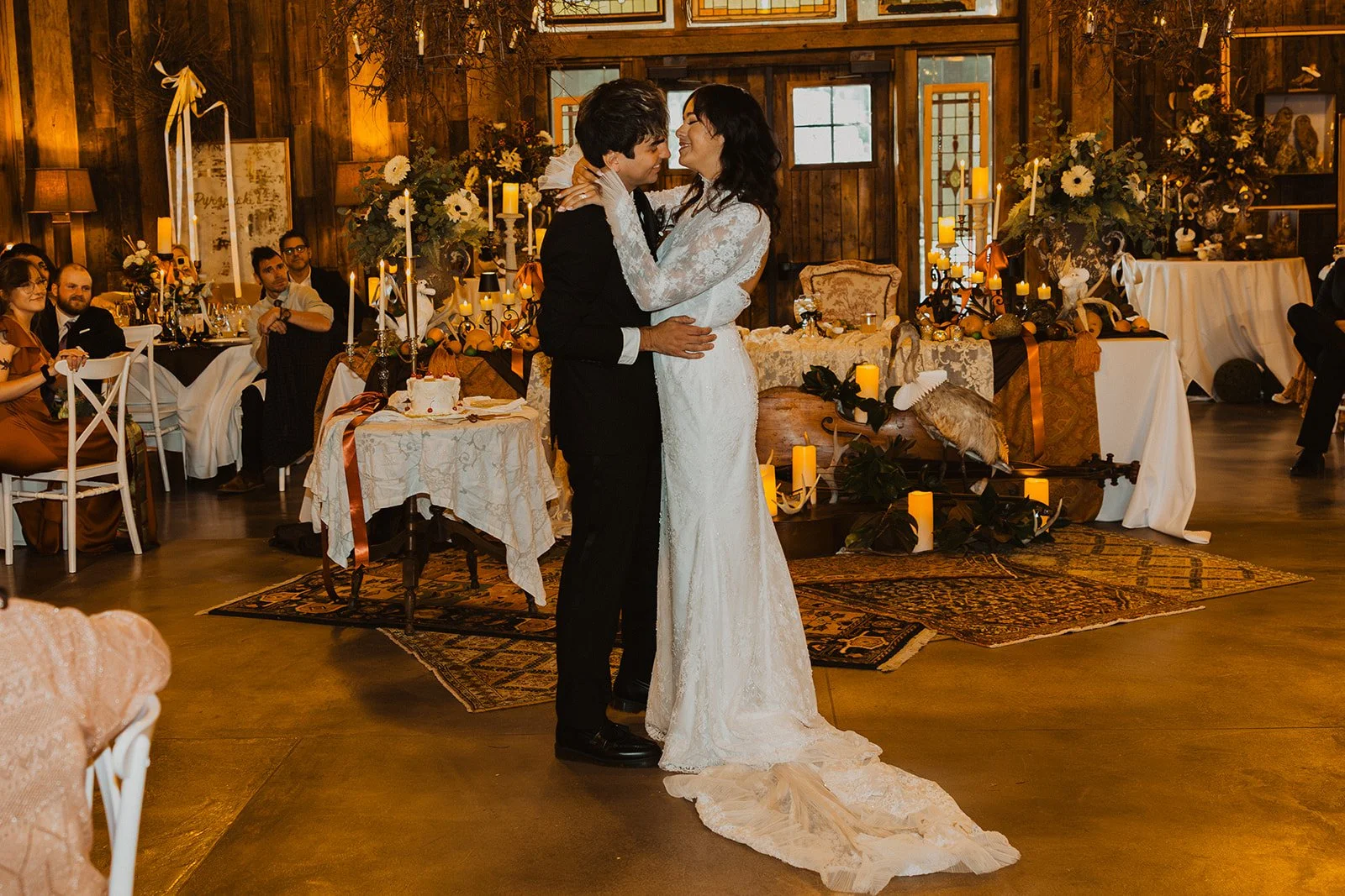 Bride and groom sharing their first dance surrounded by warm candlelight and fall-inspired reception décor at Bright Morning Farm.