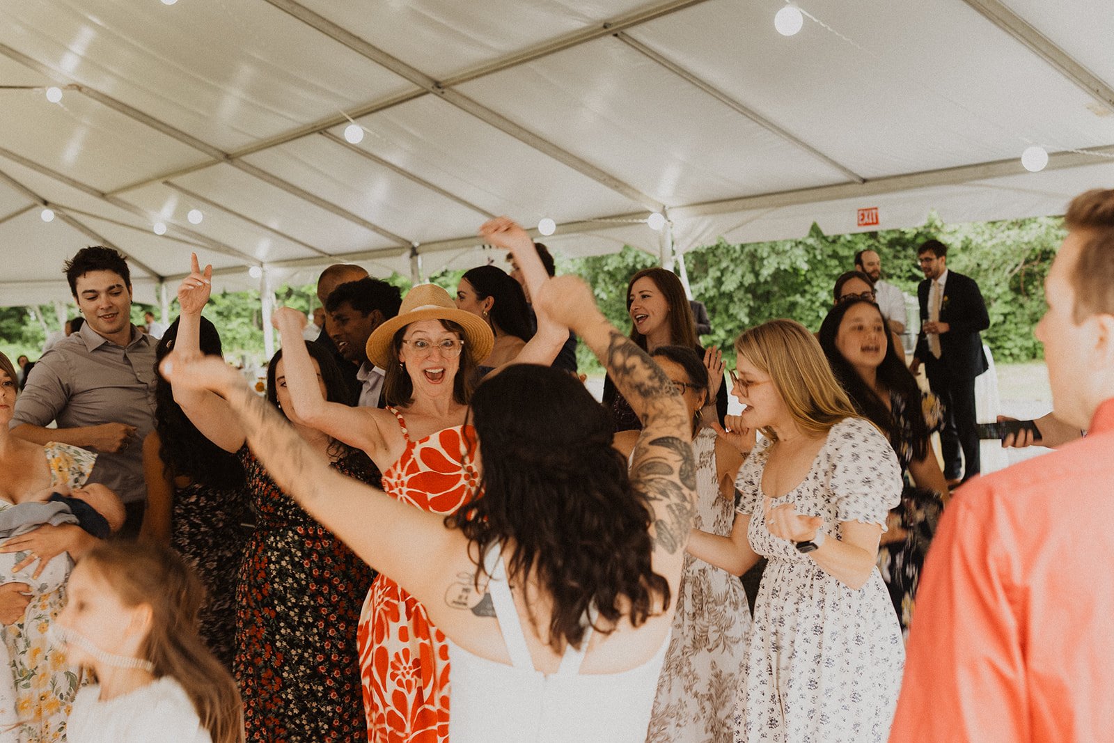 Friends laughing at cocktail hour instead of lining up for wedding party photos