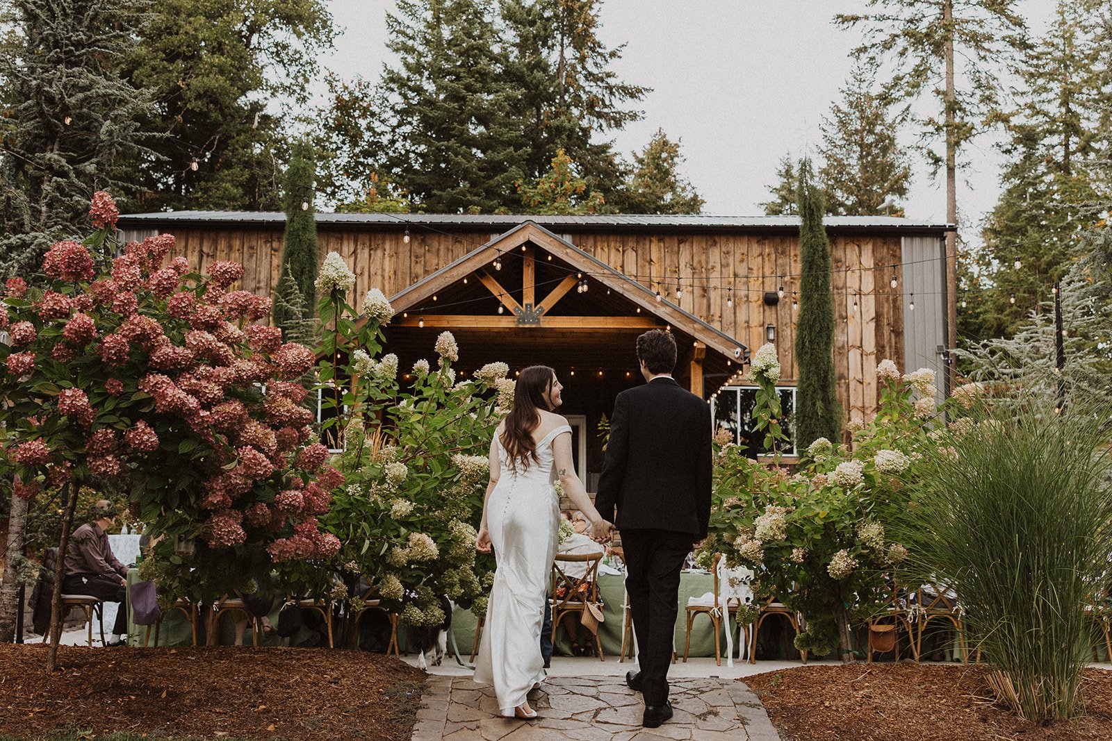 Timber reception hall strung with cafe lights at a White Salmon wedding venue
