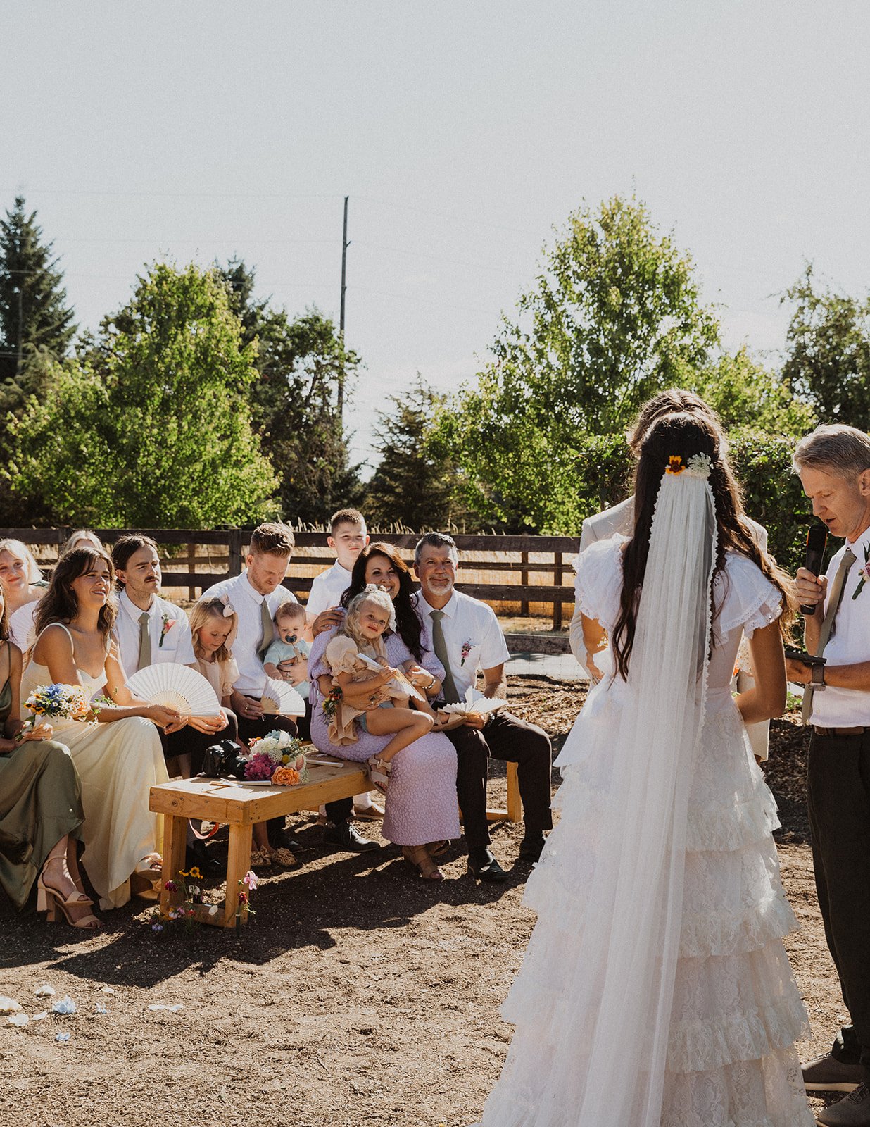 Wedding ceremony with guests seated and couple at altar during outdoor celebration