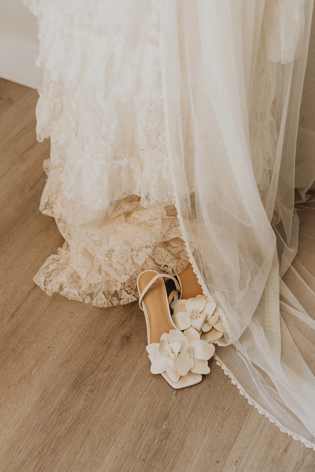 Wedding dress and bridal shoes detail with soft lace and fabric textures before ceremony