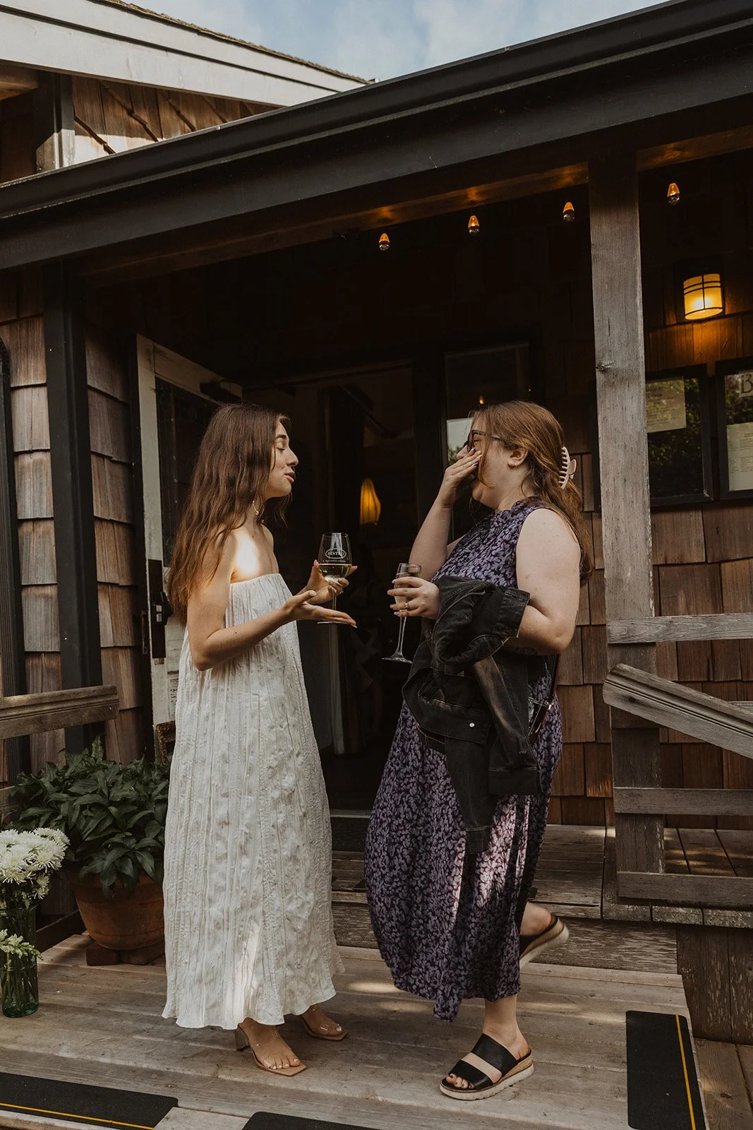 Wedding guests talking outside Bistro during a relaxed Cannon Beach wedding weekend gathering