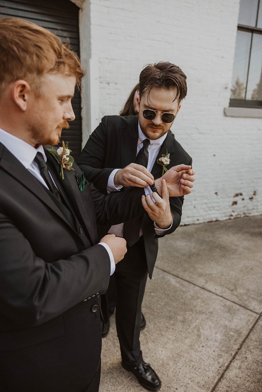 Groomsmen help each other get ready before a wedding at The Castaway in Northwest Portland.