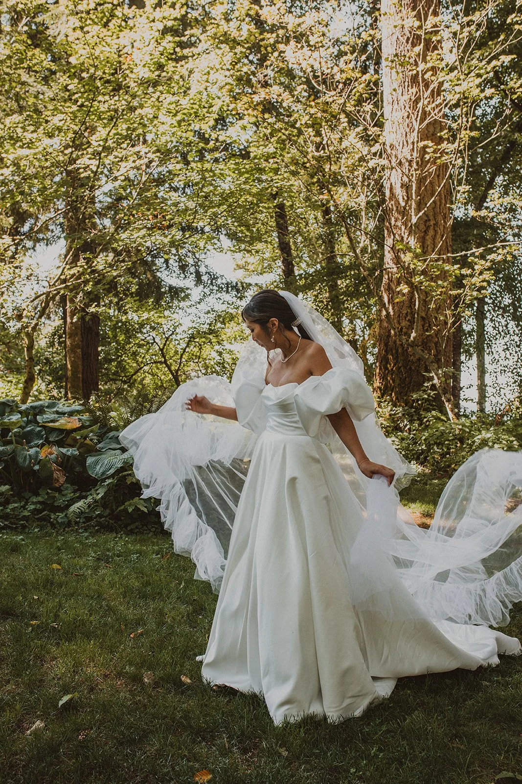 Bride twirling with her flowing cathedral veil during bridal portraits at Bridal Veil Lakes in Oregon.