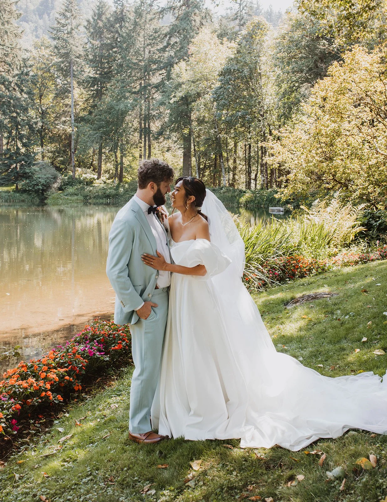 Bride and groom embracing beside the lake during romantic wedding portraits at Bridal Veil Lakes in Oregon.