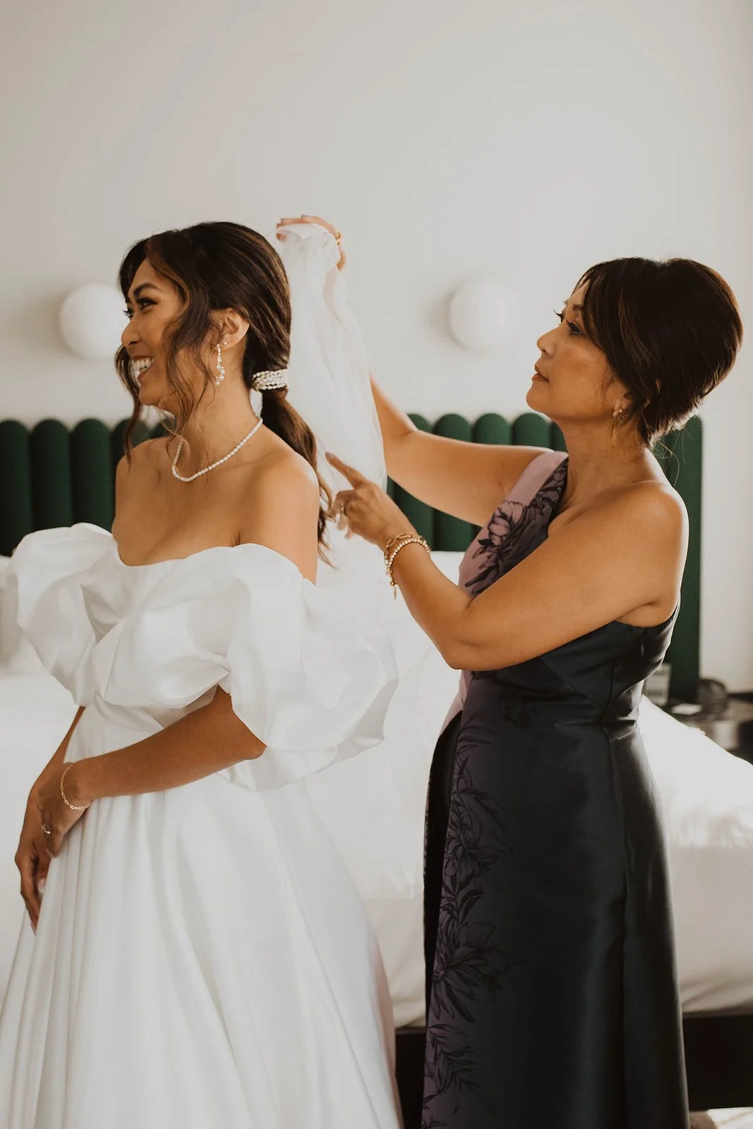 Mother carefully placing the bride's veil as they share a joyful getting-ready moment before the wedding ceremony at Bridal Veil Lakes.