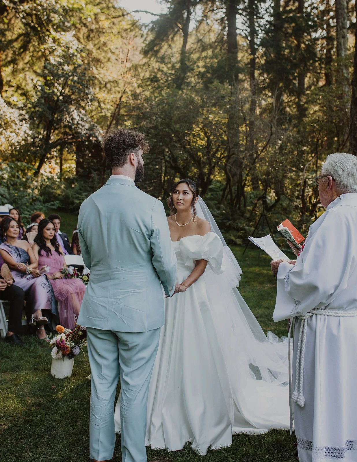 Bride and groom holding hands during their wedding ceremony at Bridal Veil Lakes in Oregon.