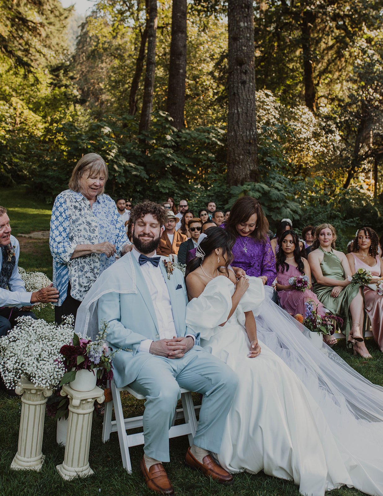 Family members placing a ceremonial stole around the newlyweds during their Bridal Veil Lakes wedding ceremony.