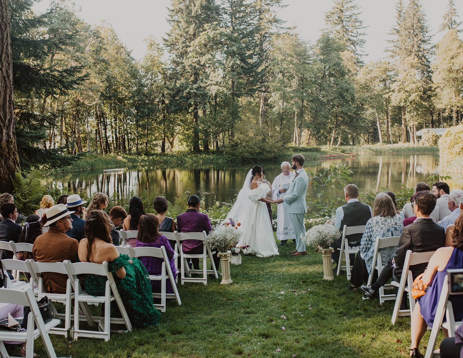 Wide view of guests gathered for an outdoor Bridal Veil Lakes wedding ceremony beside the lake in Oregon.