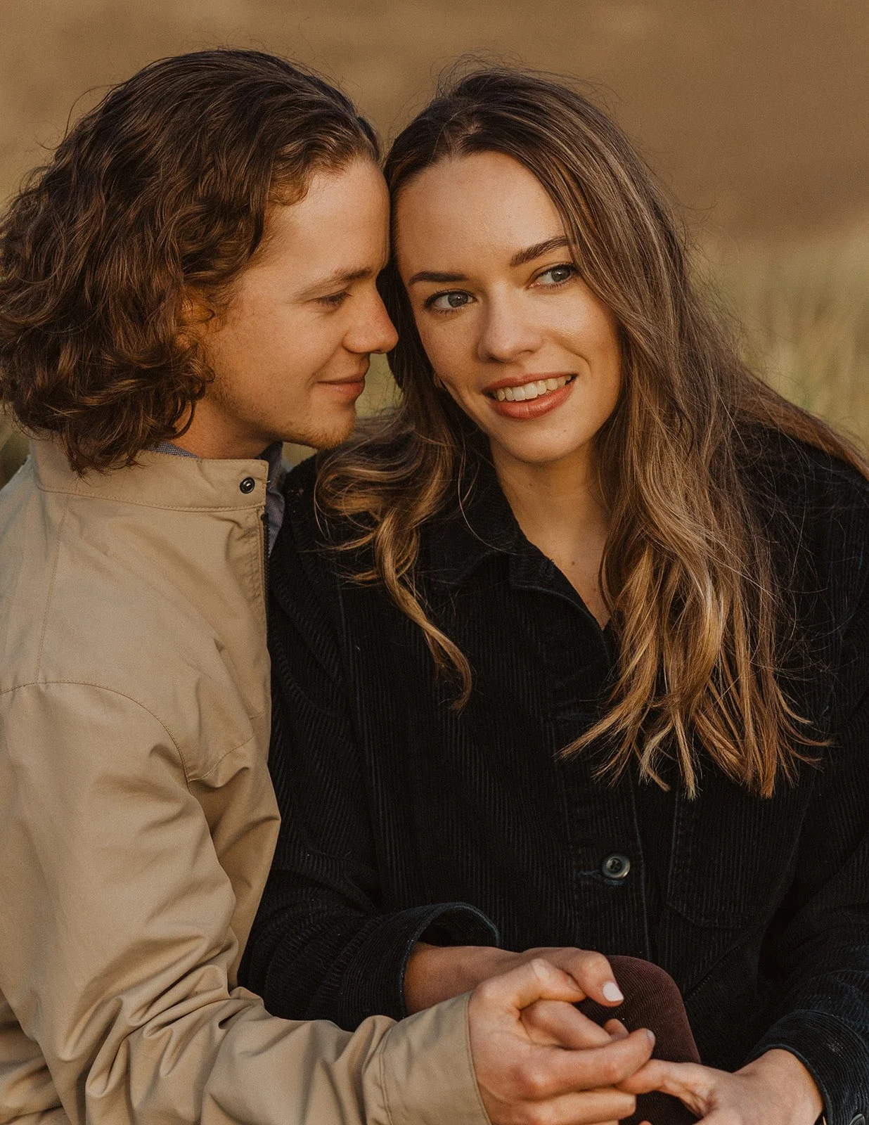 Close-up portrait of couple embracing as they share a quiet moment during their Cape Kiwanda engagement session