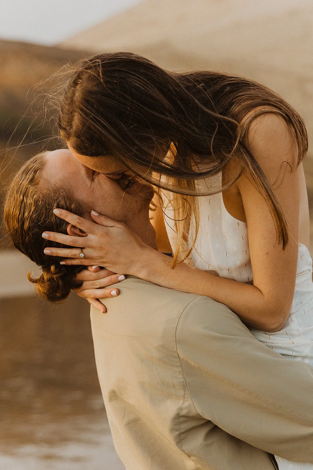 Close-up portrait of couple kissing as they share a quiet moment during their Cape Kiwanda engagement session