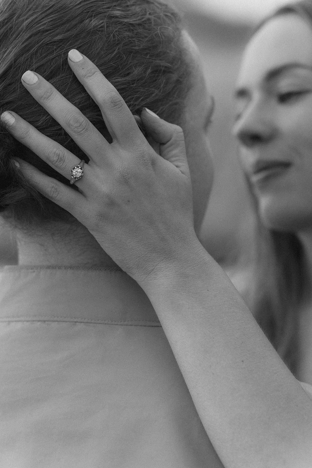 Documentary-style black and white portrait of engagement-ring