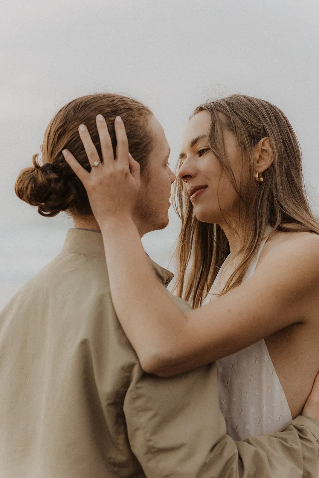 Dreamy close portrait of couple standing together during their Cape Kiwanda engagement session on the Oregon Coast