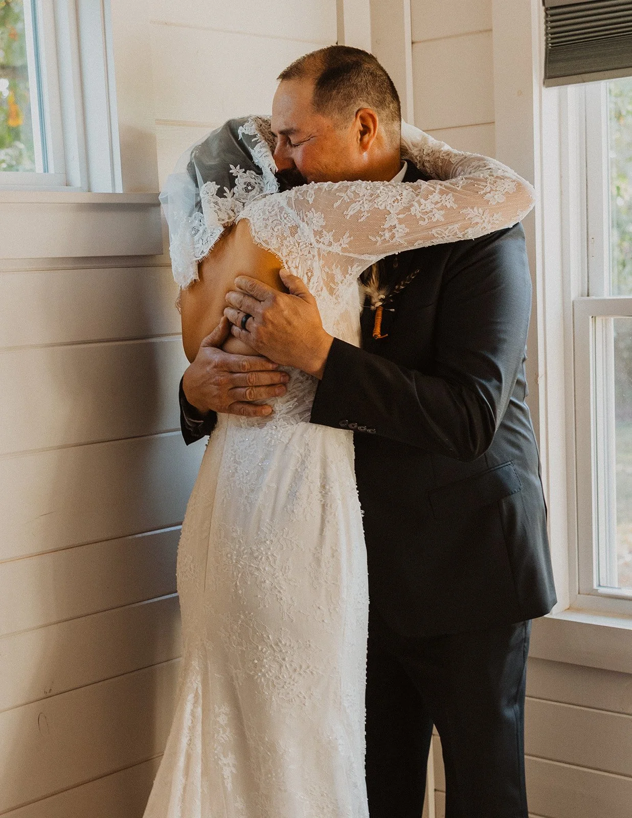 Bride embracing her father during an emotional first look before the ceremony at Bright Morning Farm.