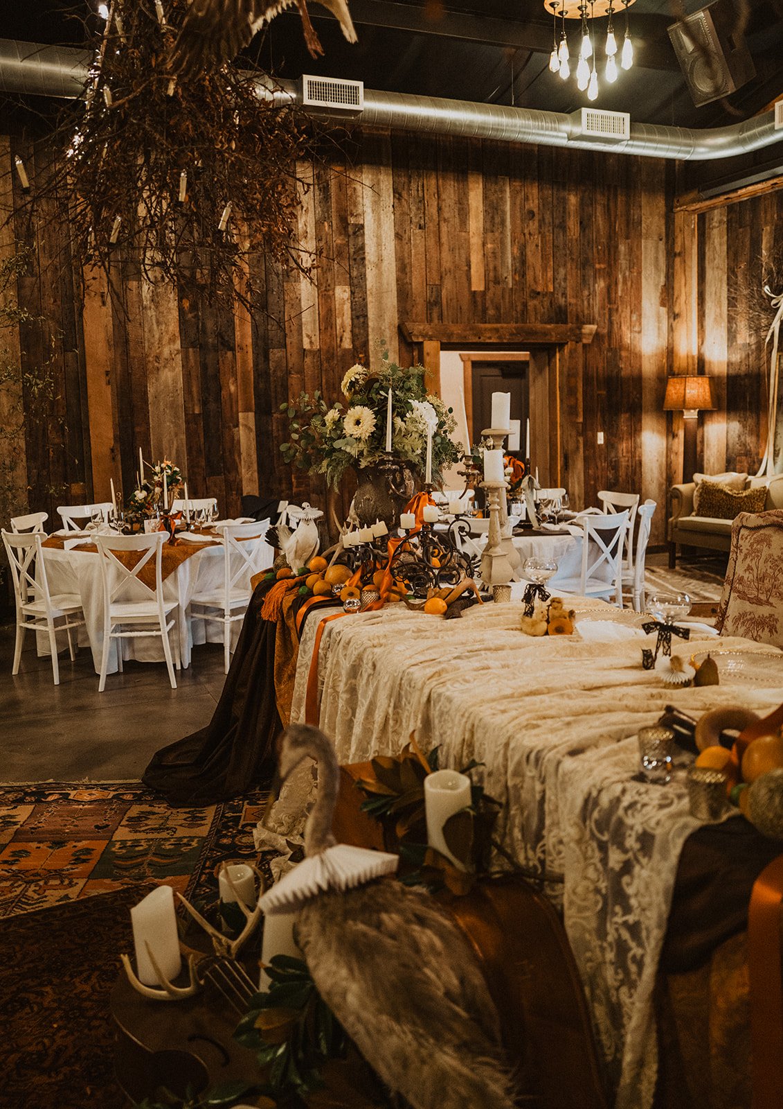 Moody wedding reception at Bright Morning Farm featuring vintage décor, candlelight, layered textiles, florals, and nature-inspired tablescapes.