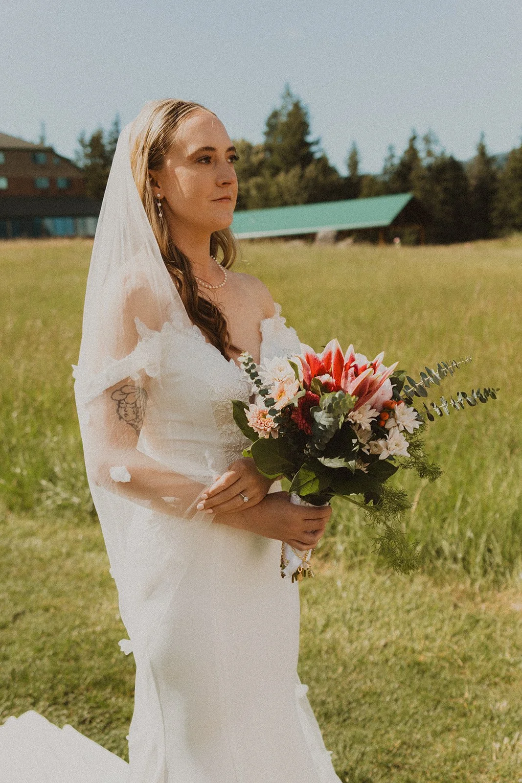Bride holding her colorful bouquet during bridal portraits on the Skamania Lodge property.