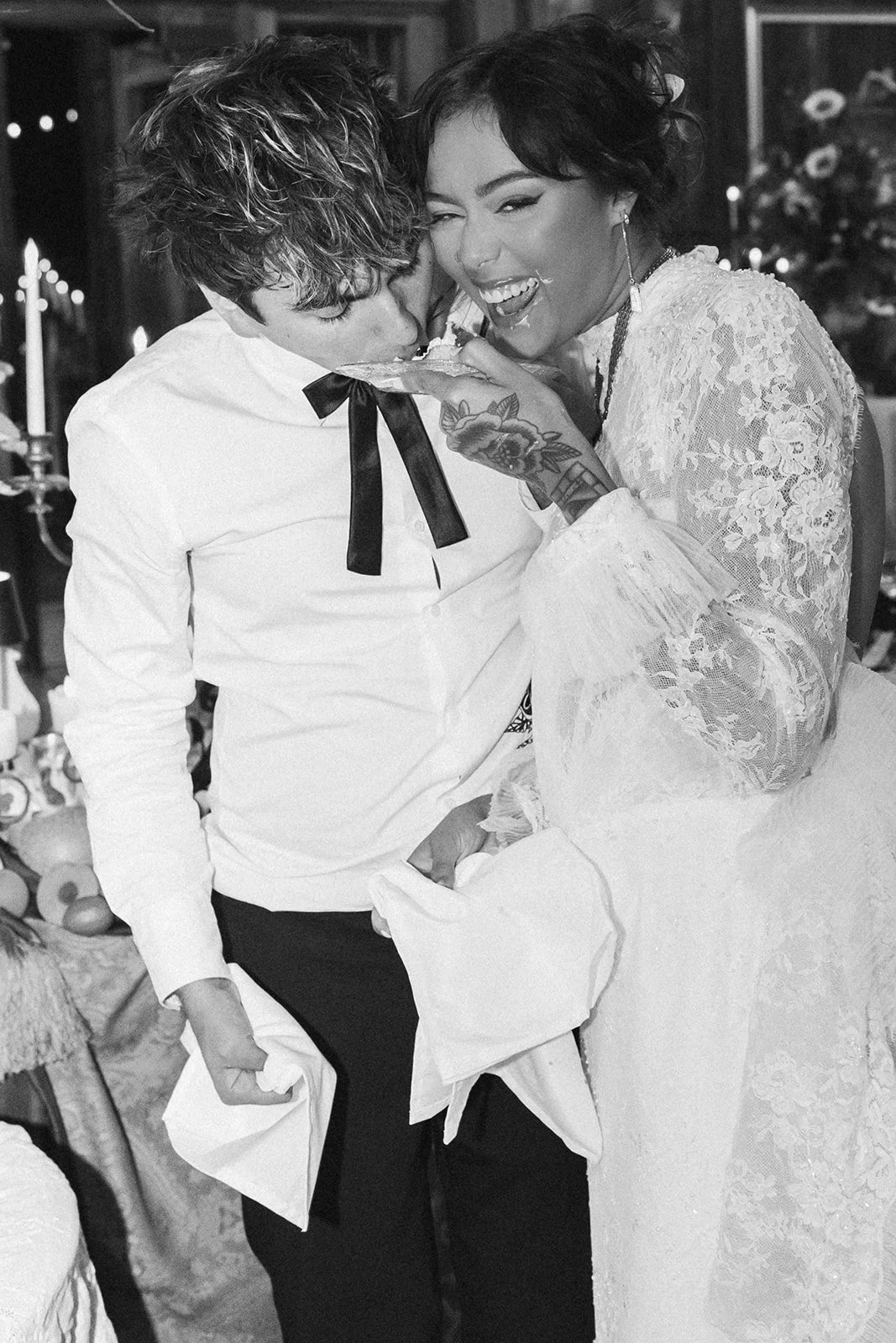 Newlyweds laughing together while cutting their wedding cake during the reception at Bright Morning Farm.