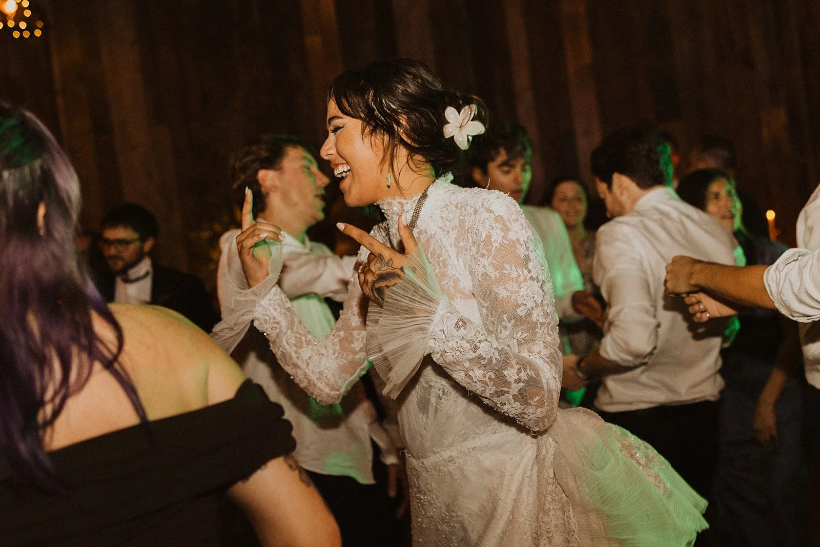 Bride dancing and laughing with guests during the wedding reception at Bright Morning Farm in Oklahoma.