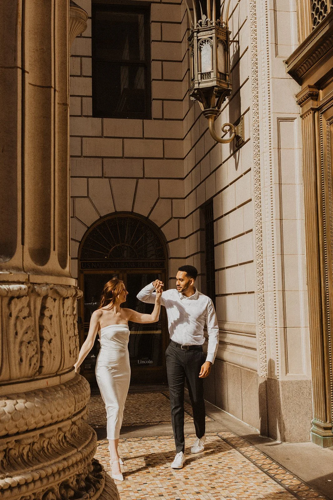 Candid engagement photo of Charlotte and Lucas together in downtown Portland
