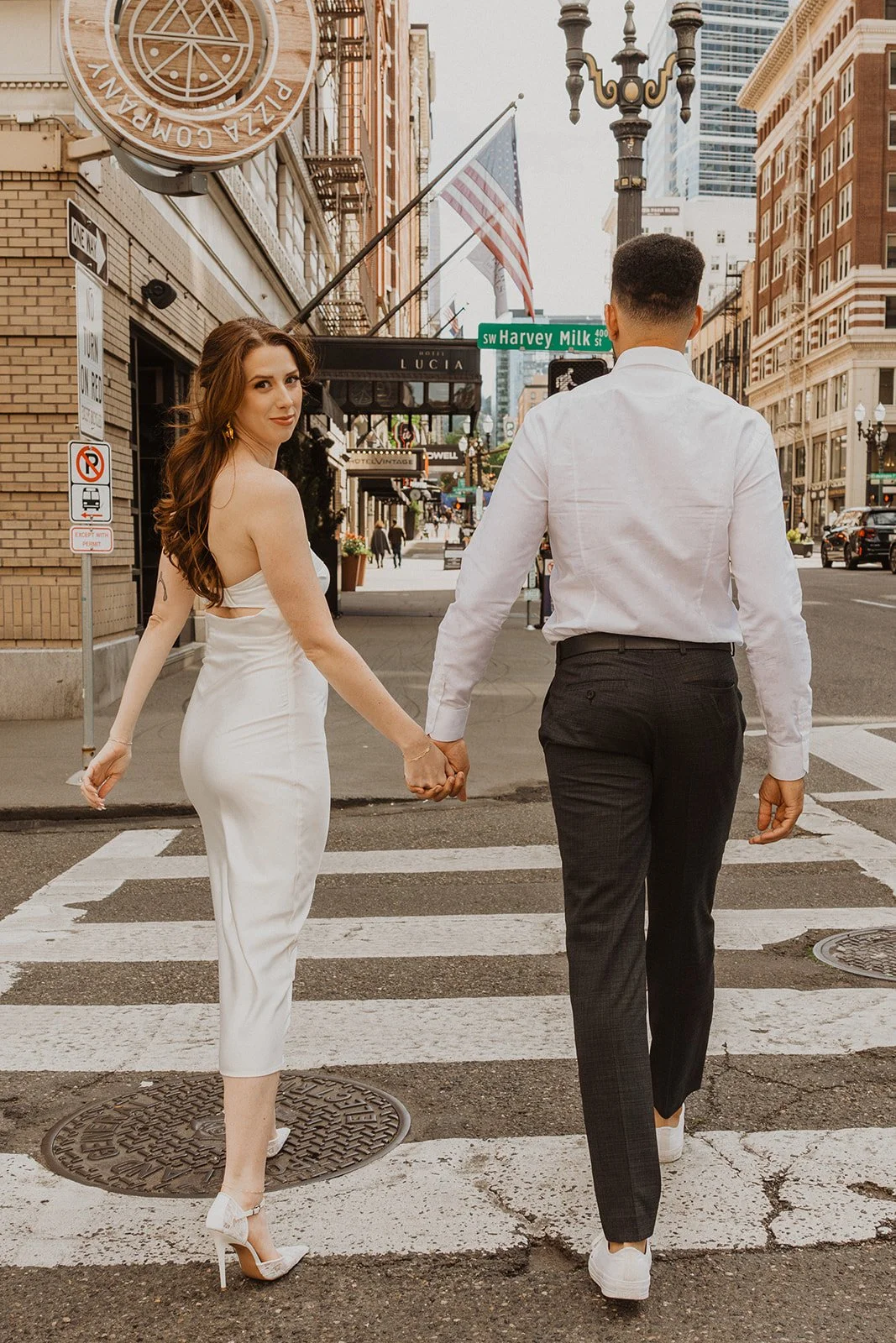 Engaged couple photographed together on the streets of downtown Portland