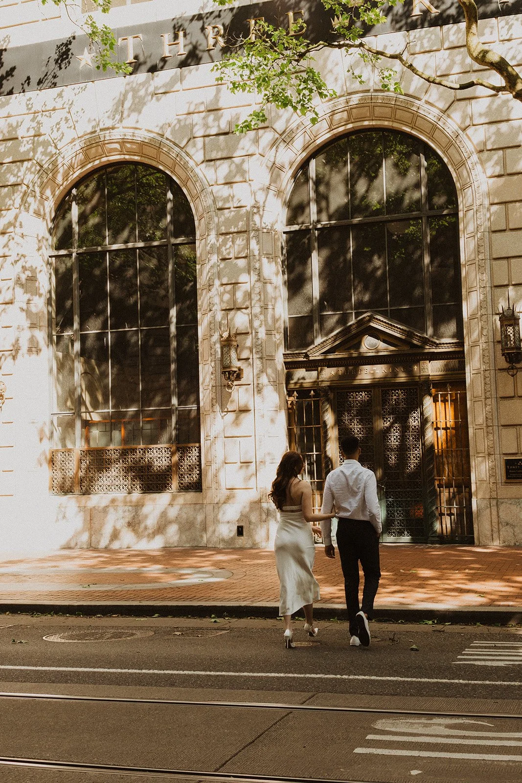 Couple photographed together at sunset during a downtown Portland date night engagement session