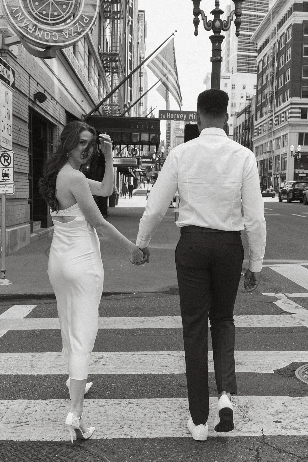 Relaxed engagement portrait of Charlotte and Lucas in downtown Portland