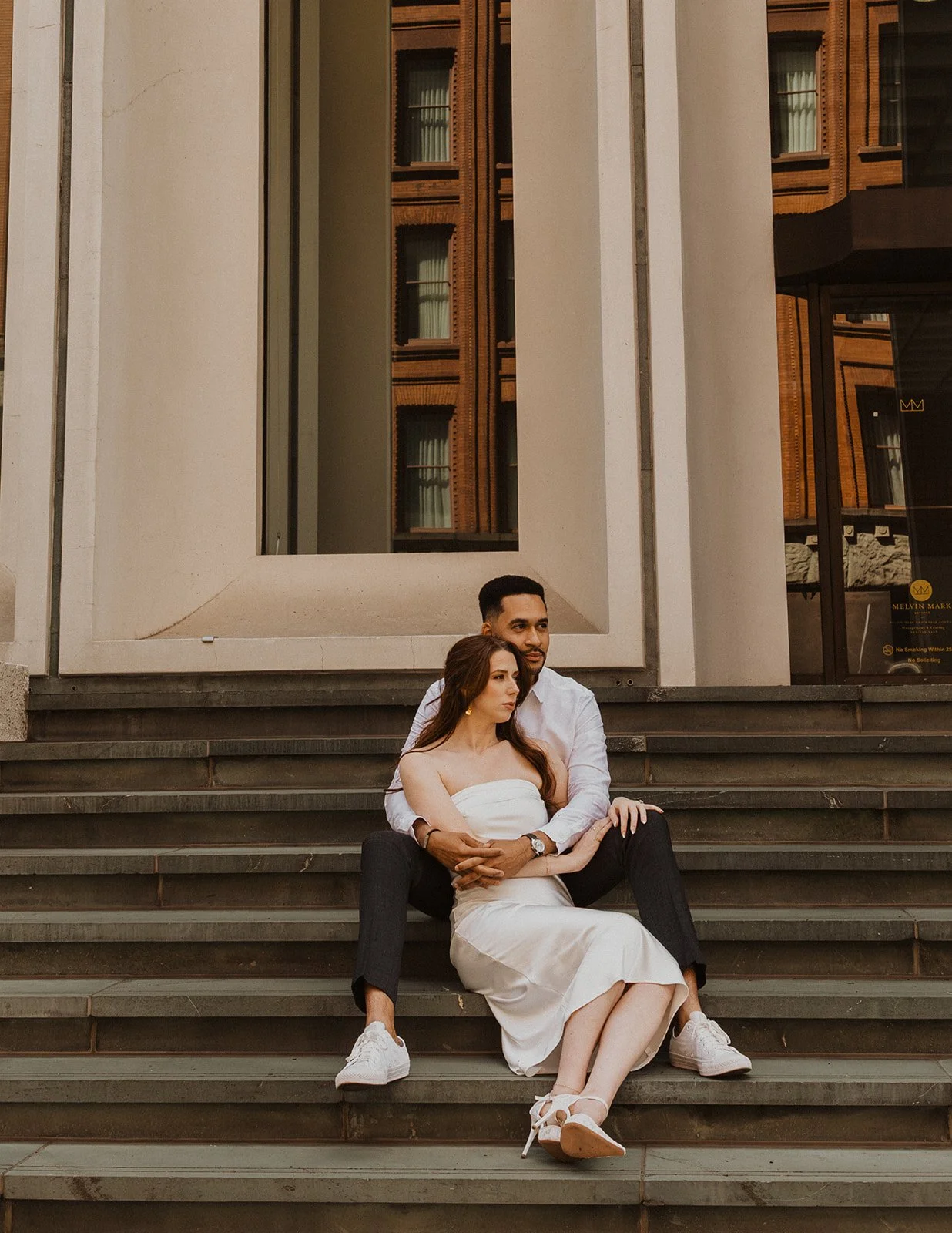 Engaged couple photographed against downtown Portland architecture