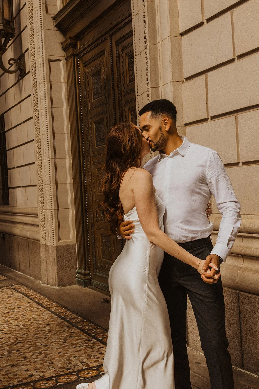 Candid interaction during Charlotte and Lucas's city engagement session in Portland