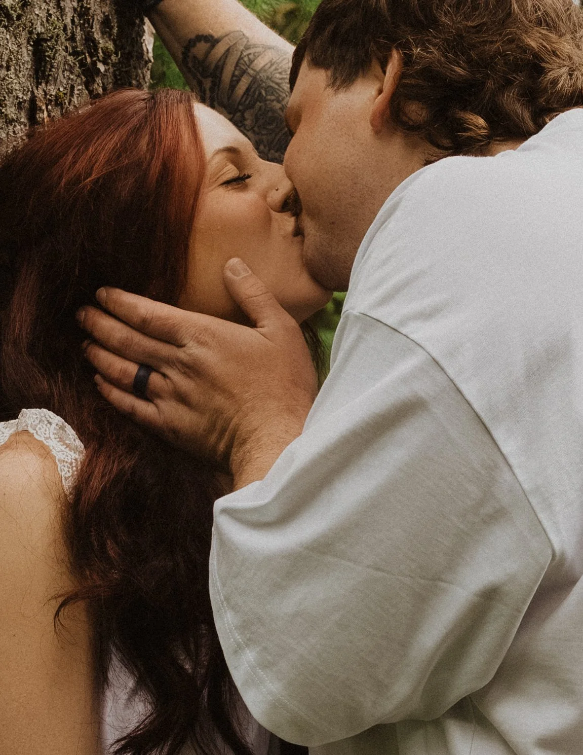 PNW forest engagement session surrounded by evergreens and low green undergrowth