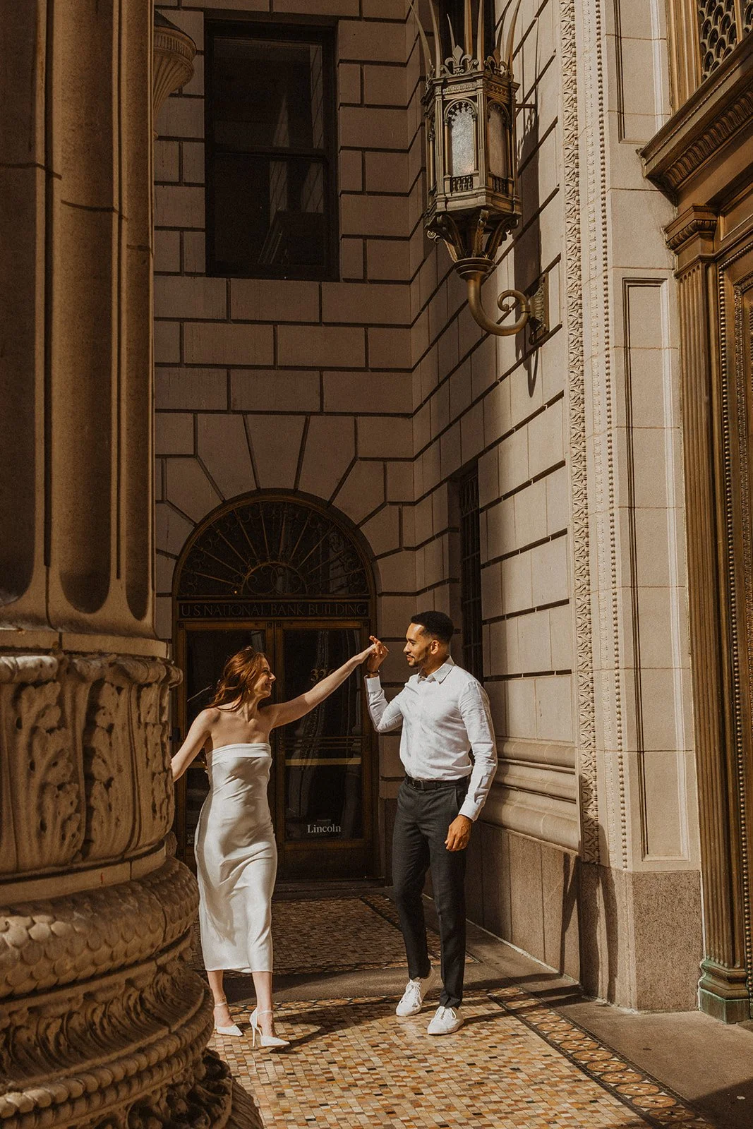 Couple walking through downtown Portland together during the last of the light