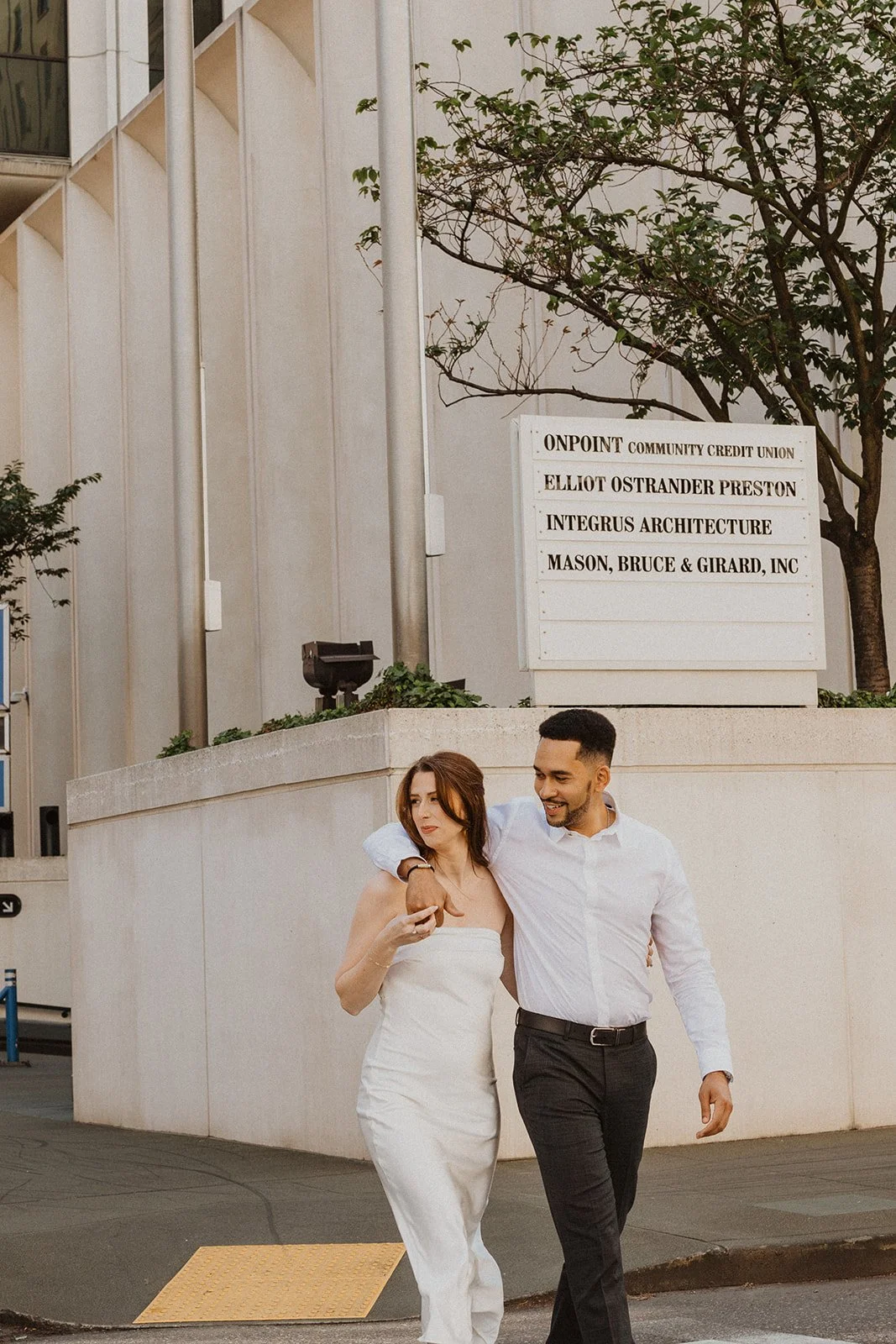 Crossing the street mid-conversation during a downtown Portland engagement session
