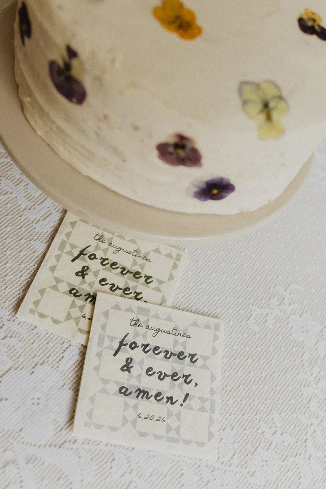 Hand-lettered sign beside a small wedding cake
