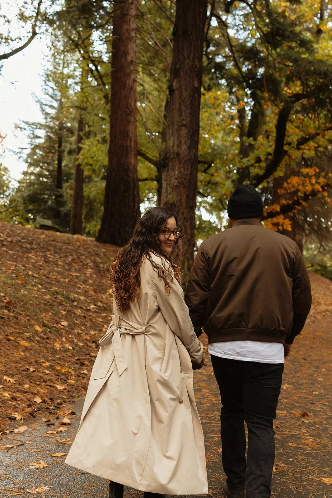 Couple walking under a gray Portland sky during a fall engagement session