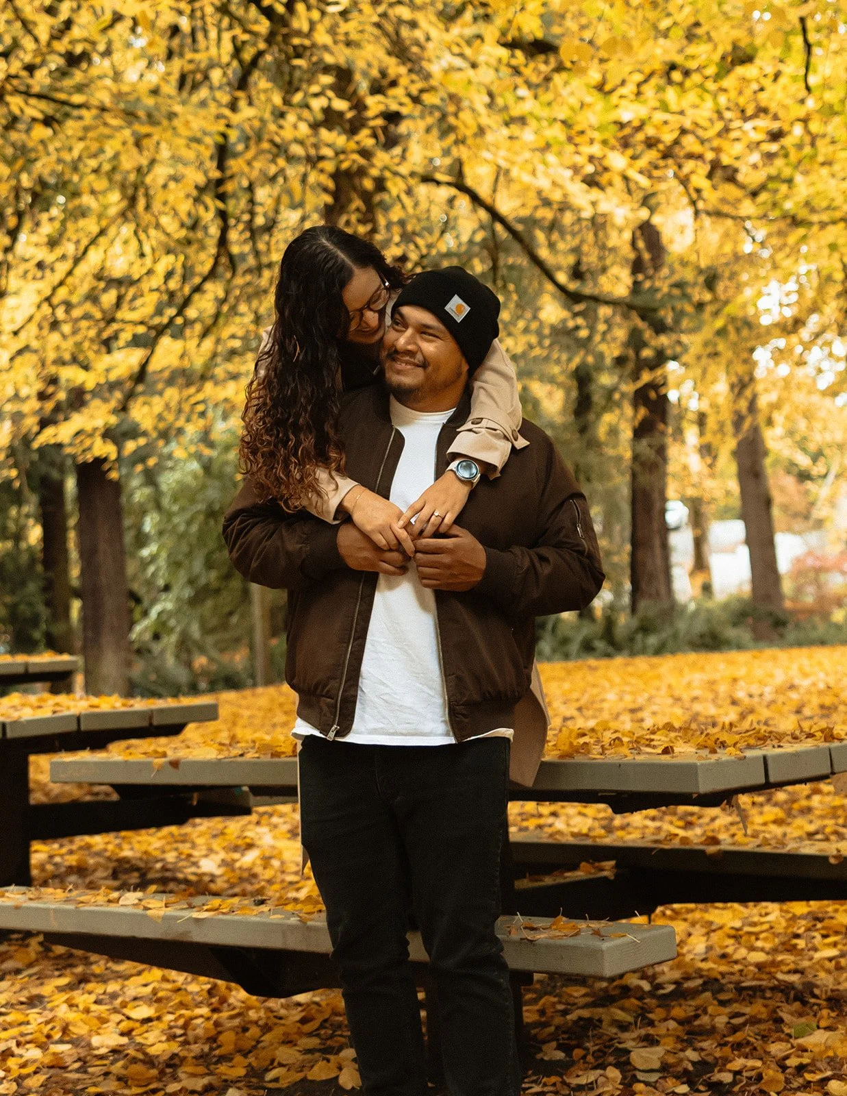 Orange and yellow leaves covering the ground during a fall engagement session