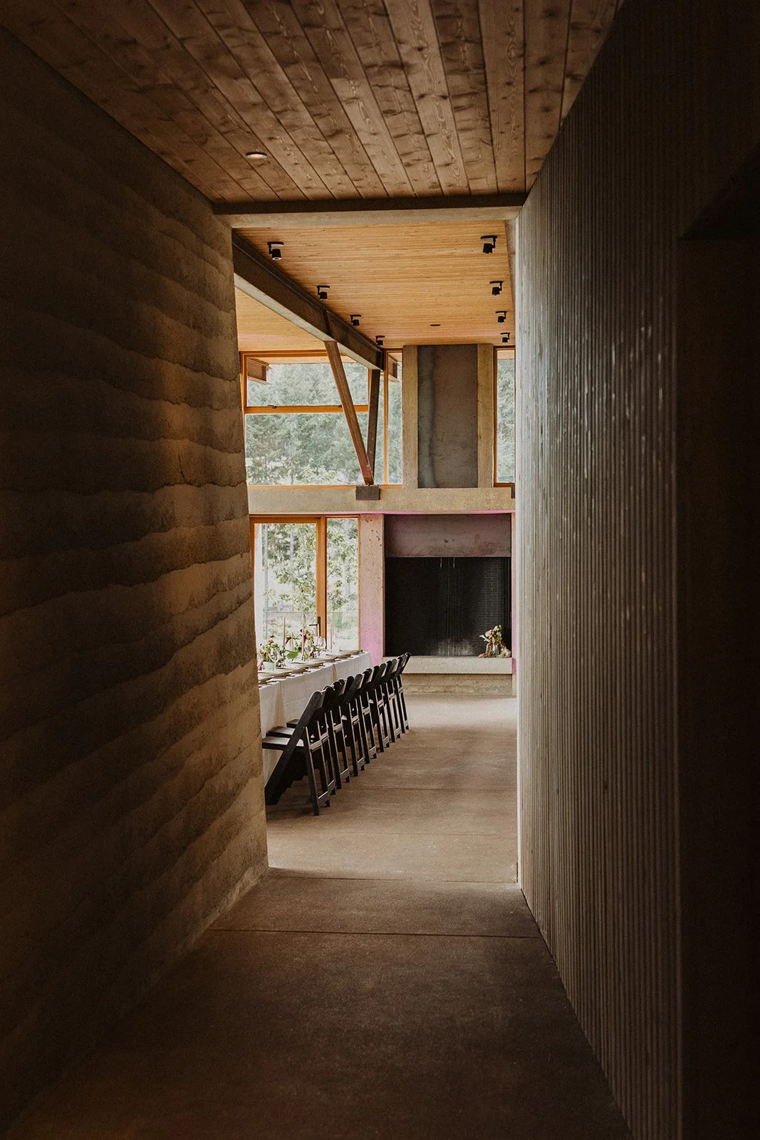 The narrow hallway that compresses before the main room opens up for summer winery wedding