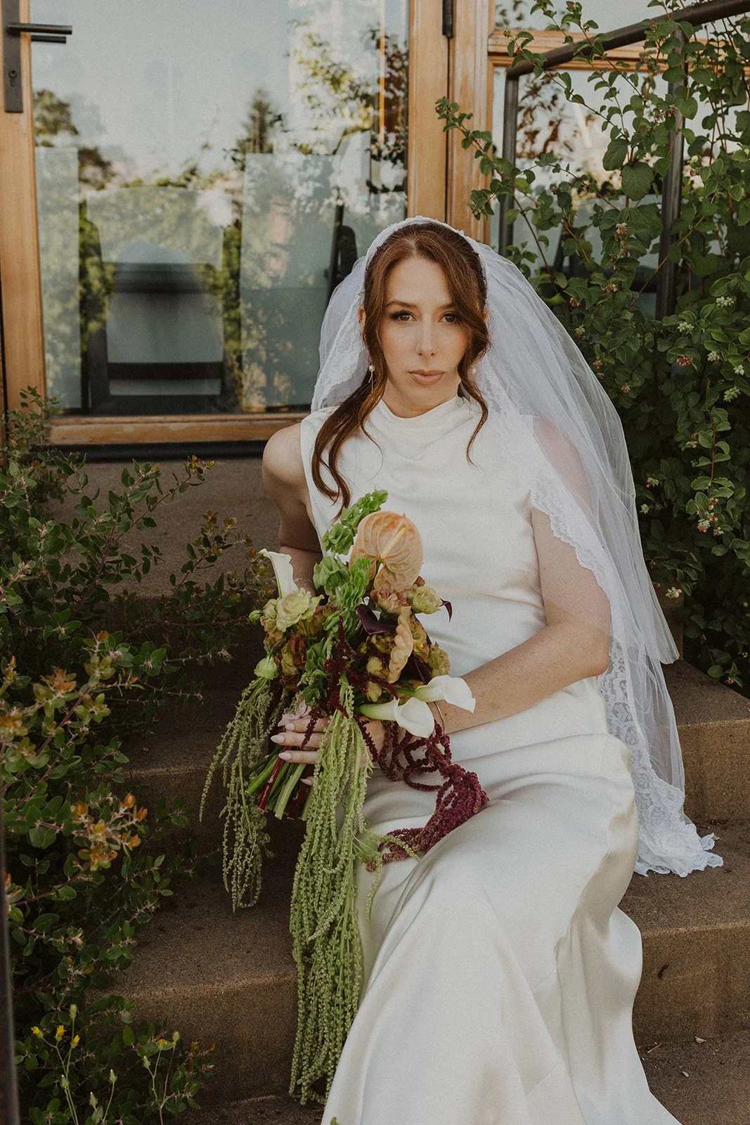 Bridal portrait with trailing amaranthus at a Rodeo Hills Winery wedding