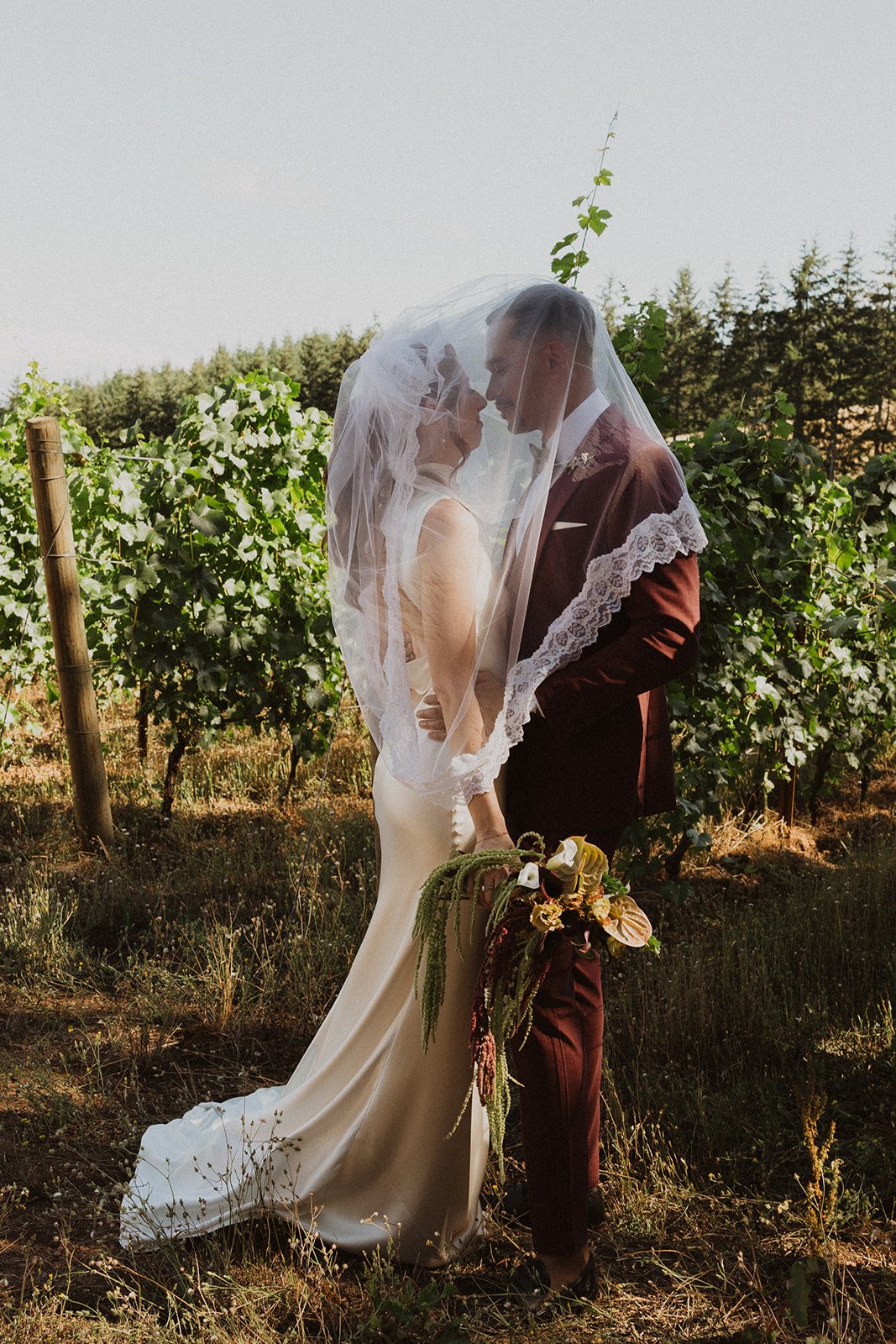 Full green canopy behind a first look at a Willamette Valley wedding