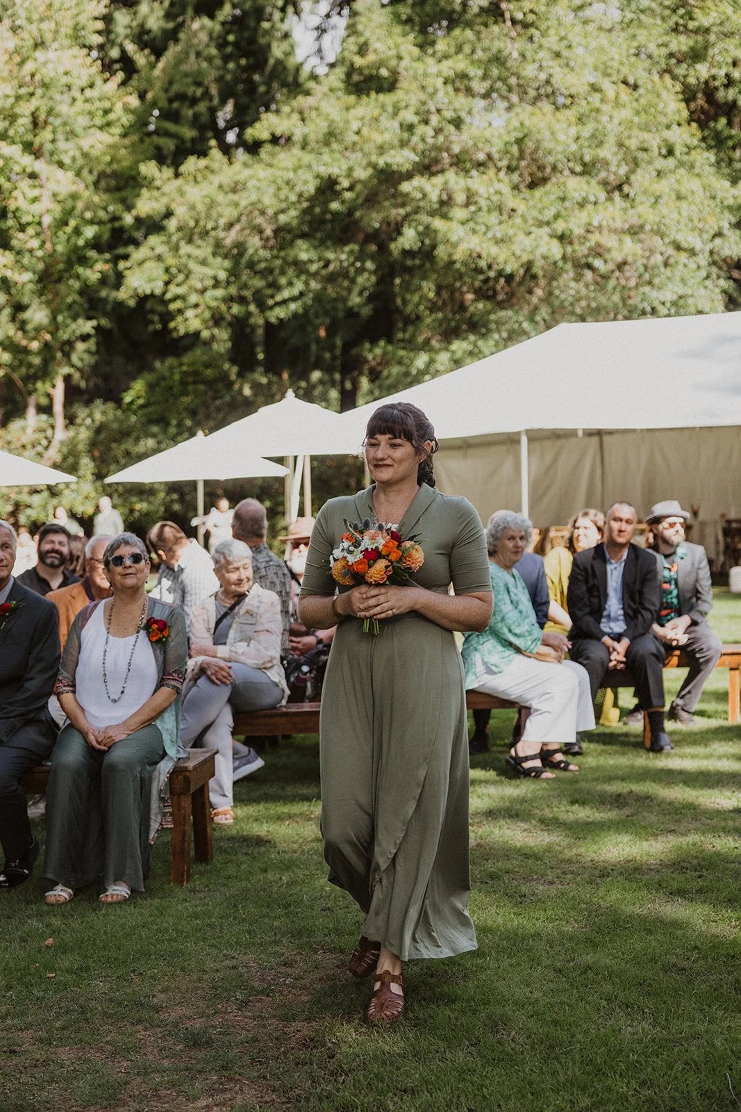 Arriving guests walk the path toward a Crystal Springs Rhododendron Garden wedding