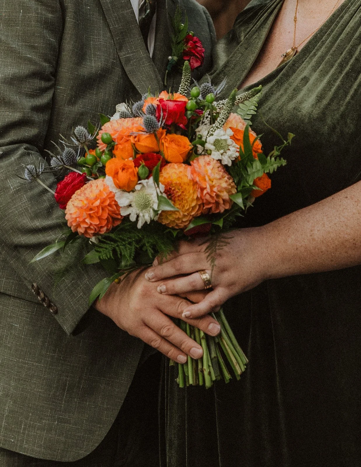Autumn bouquet of dahlias and thistle held against velvet at Crystal Springs