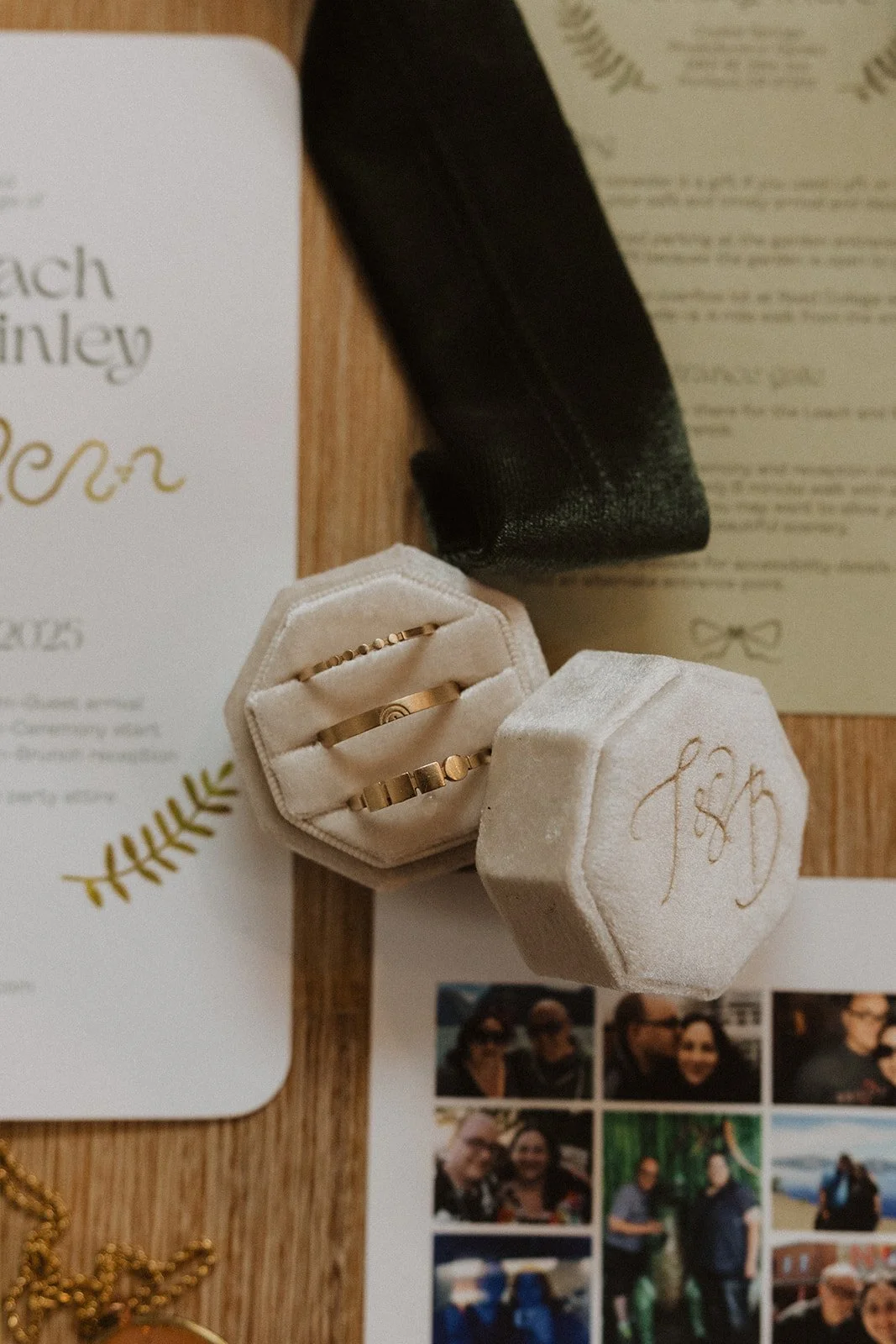 Monogrammed ivory velvet ring box resting on ferns and fallen autumn leaves