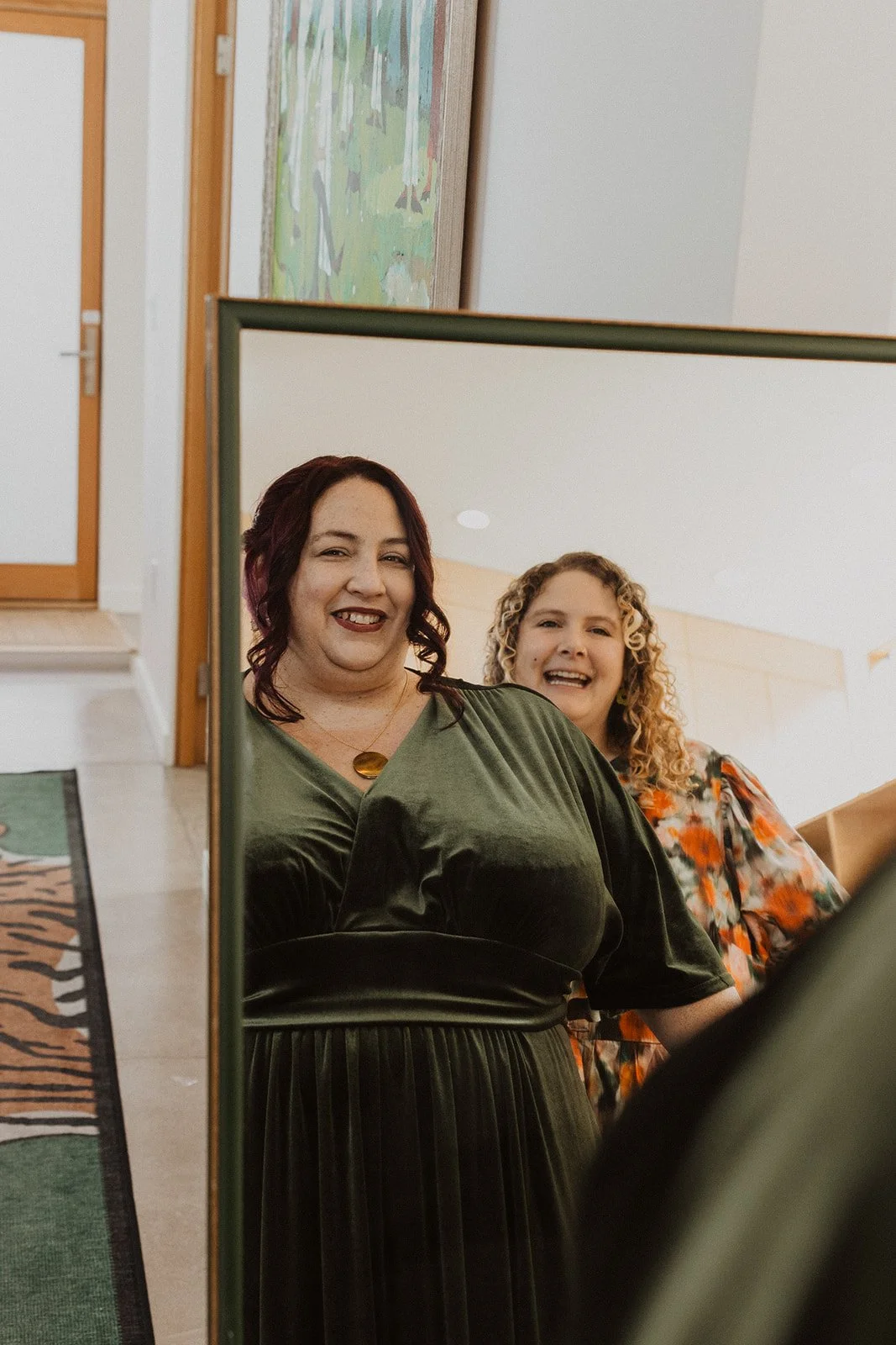 Bride in forest green velvet reflected in a mirror before her Crystal Springs wedding