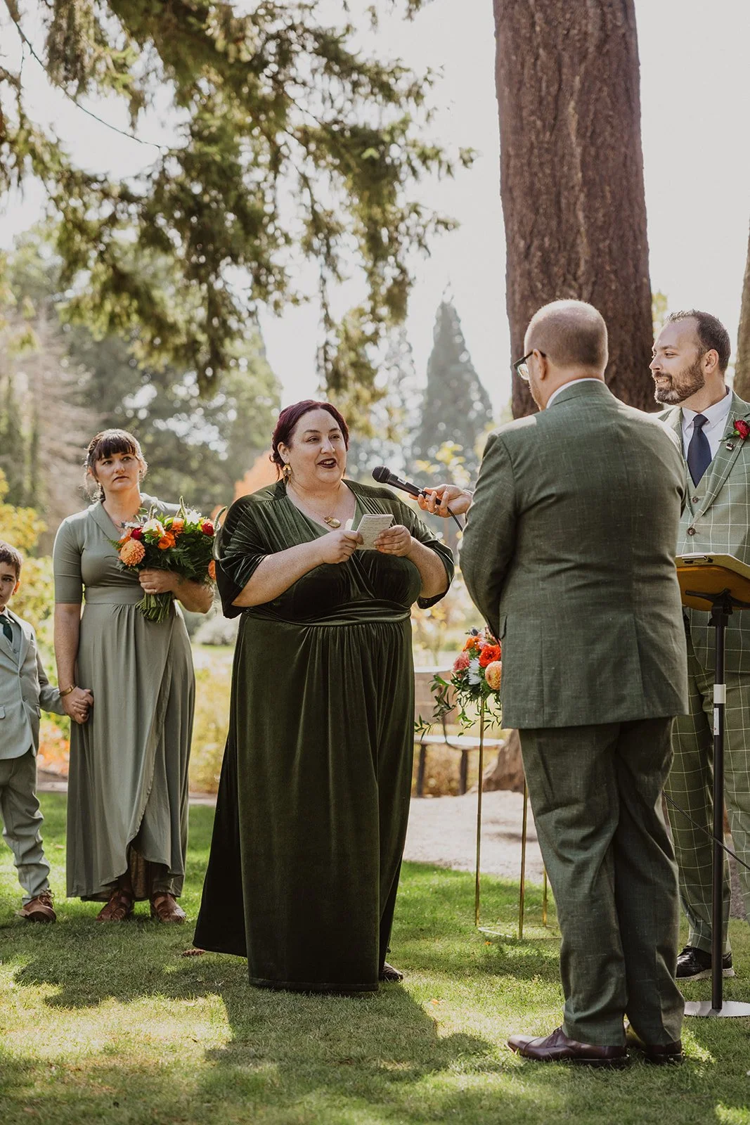 Holding the microphone steady while she reads her vows to him