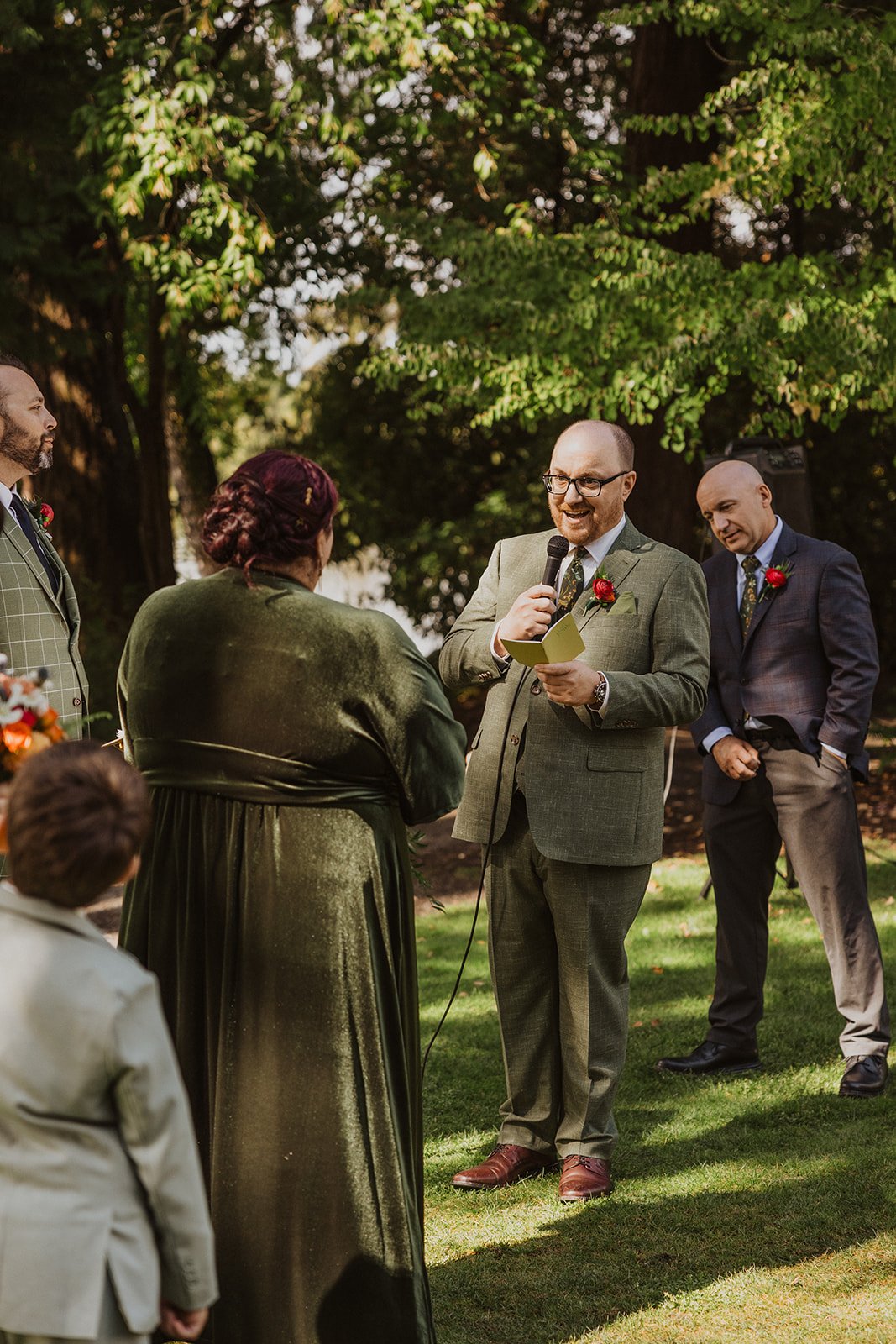 Reading vows into a microphone on the Meadow lawn at Crystal Springs