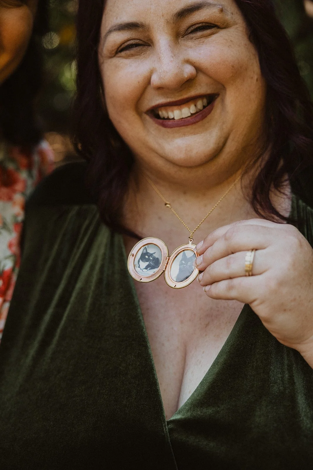 Vintage gold locket opened to show photographs of the couple's two cats