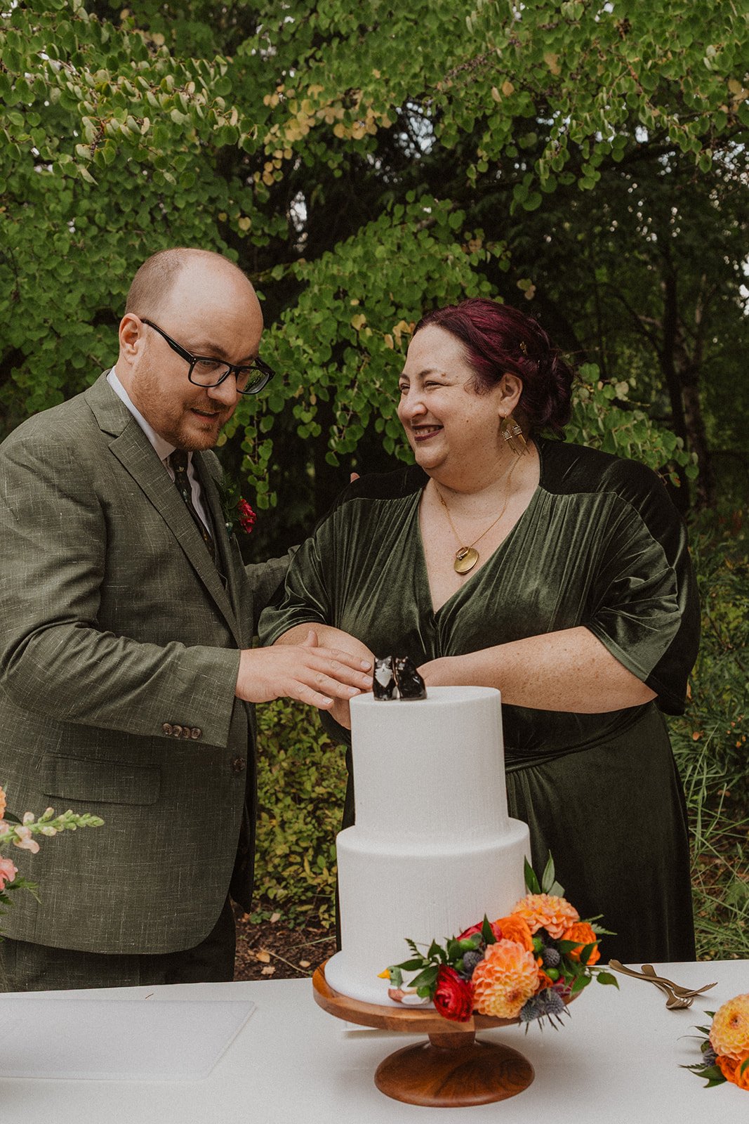 Cutting the cake together under the reception tent on the Meadow lawn