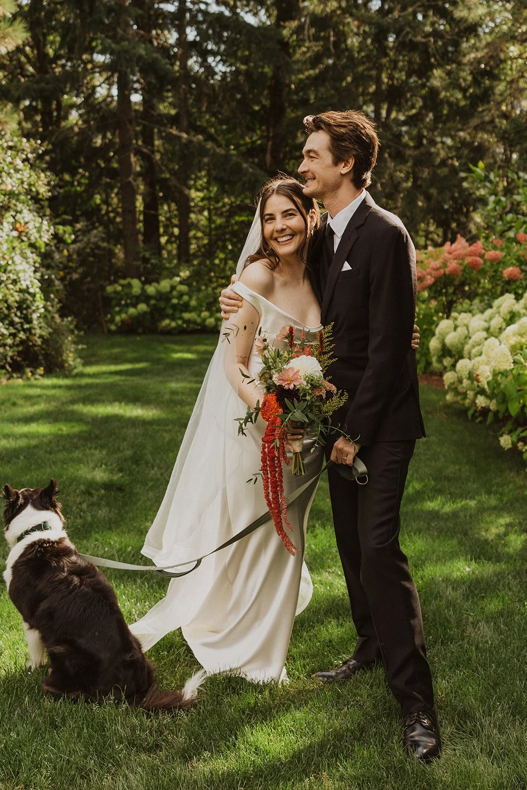 Laughing while walking toward the camera in an off shoulder cowl gown